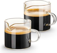 two mugs filled with liquid sitting next to each other