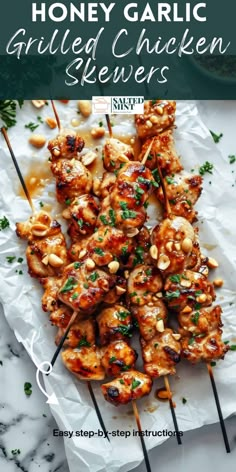 honey garlic grilled chicken skewers on a white plate with text overlay