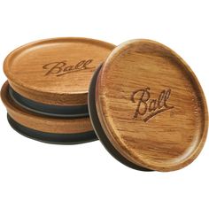 three wooden coasters with the word ball engraved on them, sitting side by side