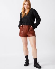 Crafted for comfort and style, the FAUX THE RECORD short features a wide elastic waistband that is both chic and versatile. The faux leather material adds a touch of ruggedness, while the pull-on design allows for easy wear. Faux leather shorts Two functional side pockets Inseam: 2" Length: 14" 100% polyurethane Care instructions: wipe clean with a damp cloth, do not bleach, line dry, use pressing cloth and iron on low if necessary, do not dry clean Shop the set here Amy is 5ft 11in and is weari Faux Leather Shorts, Color Bone, Leather Short, Top Skirt Set, Swimwear Sets, Top Pants Set, Strapless Tops, Elastic Waist Shorts, Leather Shorts