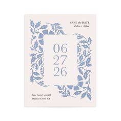 save the date card with blue flowers and leaves on it, printed in white paper