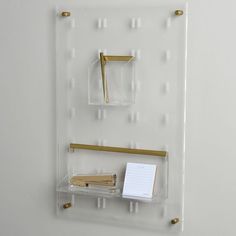 there is a clear shelf with some writing on it and a notepad in the middle