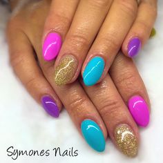 Mix and Match almond Sculptured acrylic nails, Slurple Purple, Jupiter Blue, Gold Glitter, and Cashmere Cutie #pastelnails #symonesnails #ibdbeauty #nailart #glitternails Purple And Gold Almond Nails, Blue And Purple Almond Nails, Pink Purple Blue Nails, Purple Sparkle Almond Nails, Aqua Blue And Purple Nails, Blue And Purple Sparkle Nails, Ombre Manicure, Sunset Nails, New Nail Art Design