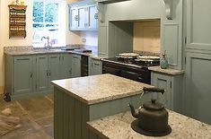 a tea kettle sitting on top of a kitchen counter next to an oven and sink