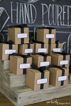 many boxes are stacked on top of each other in front of a chalkboard wall