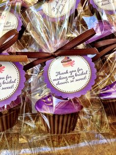 chocolate cupcakes wrapped in plastic wrappers with thank you for making sweet tags