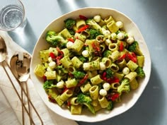 a white bowl filled with pasta and broccoli