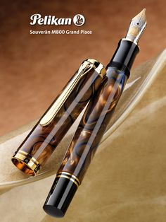 two fountain pens sitting next to each other