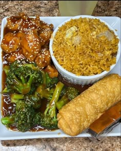 a white plate topped with rice and broccoli next to a bowl of chicken