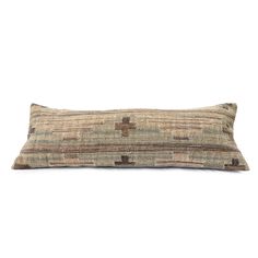 a rectangular pillow with brown and tan squares on it