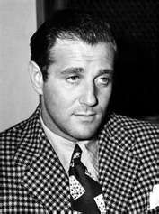 a black and white photo of a man wearing a suit with a checkered jacket