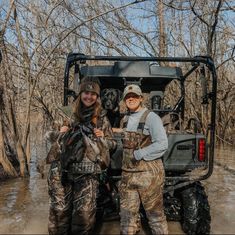 two women standing next to each other in the mud