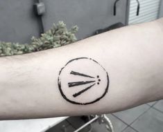 a person's arm with a tattoo on it that has a clock and arrows