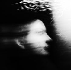 a blurry image of a person's face in black and white