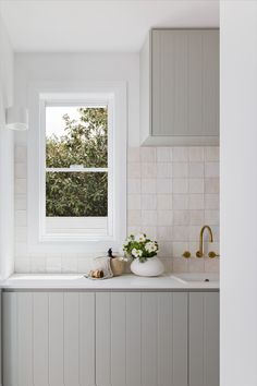 a kitchen with a sink, window and counter top in it's center area