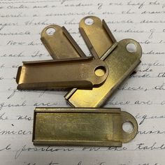 three brass plated keys laying on top of a piece of paper