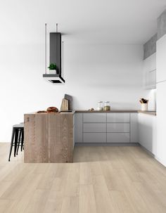 a kitchen with white walls and wooden floors