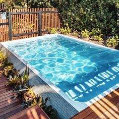 an above ground swimming pool surrounded by greenery