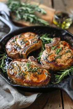 pork chops in a cast iron skillet with herbs