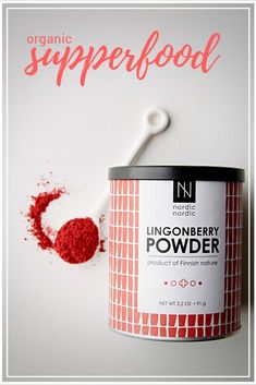 a can of red powder next to a toothbrush on a white surface with the word linonberry powder in it