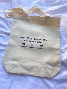 Embroidered Custom Song Tote Bag Example says Say you love me by Fleetwood Mac Toat Bags Design Diy, Totes Painting Ideas, Tote Bag Designs Aesthetic, Custom Tote Bags Painting, Cute Tote Bags Design, Tote Bag Inspo Aesthetic, Painting Ideas Tote Bag, Design Totebag Aesthetic, Tote Bag Embroidery Ideas Aesthetic