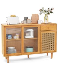 a wooden sideboard with glass doors and shelves filled with dishes, cups, vases and flowers