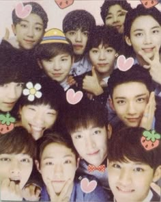 a group of young men and women posing for a photo with hearts on their foreheads