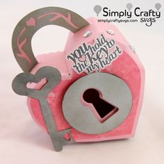 a close up of a pink and gray box with a key