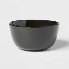 a black bowl sitting on top of a white table