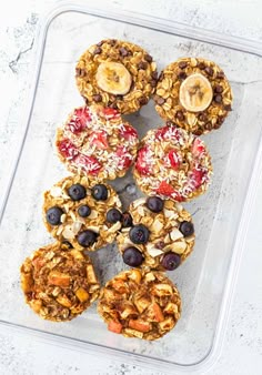 granola breakfast muffins in a plastic container with fruit and nuts on top