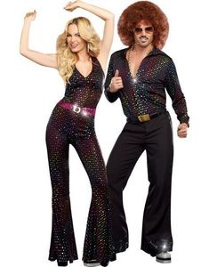 two people dressed in disco outfits posing for the camera