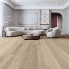 an elegant living room with white furniture and wood flooring, along with chandelier