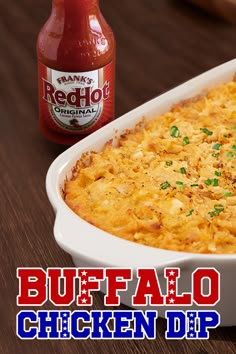 buffalo chicken dip in a white casserole dish next to a bottle of ketchup