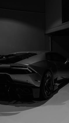 a black sports car parked in a garage