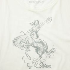 a white t - shirt with a drawing of a woman riding a horse