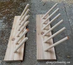 two wooden pegs are sitting on the ground next to each other and one is made out of wood