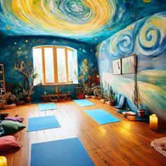 a room with yoga mats and paintings on the walls