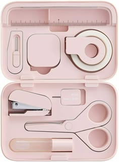 an open pink case with scissors, tape and other items