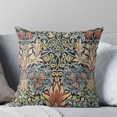 an intricately designed pillow on a couch