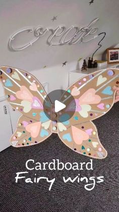 a cardboard butterfly sitting on top of a carpet