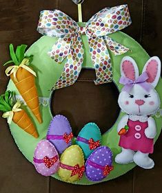 a wreath with an easter bunny and carrots on it