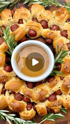 hot dogs and pretzels on a platter with a cup of dipping sauce