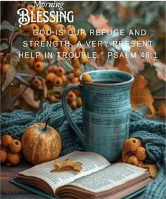 an open book and cup on top of a blanket with autumn leaves around it, the words morning blessing god - is our refuge and strength a very present help in trouble