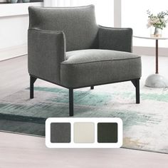 a gray chair sitting on top of a rug in a living room