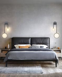 a large bed sitting in a bedroom next to two lamps on the side of a wall