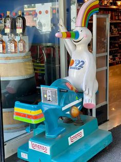 an inflatable toy horse is on display at a store window with other items behind it