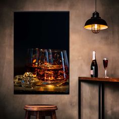 two glasses of alcohol on a table with ice cubes