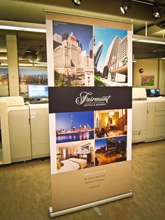 a large sign in an office building with pictures on it's front and back