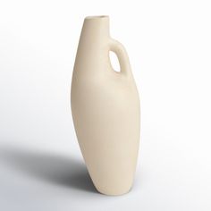 a white vase sitting on top of a table next to a white wall and floor