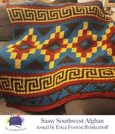 a crocheted afghan sitting on top of a couch